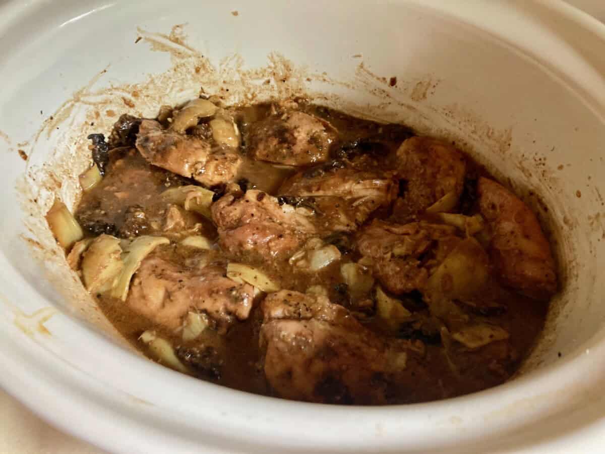 Cooked Chicken Thighs with sun dried tomatoes, artichoke hearts in the crockpot