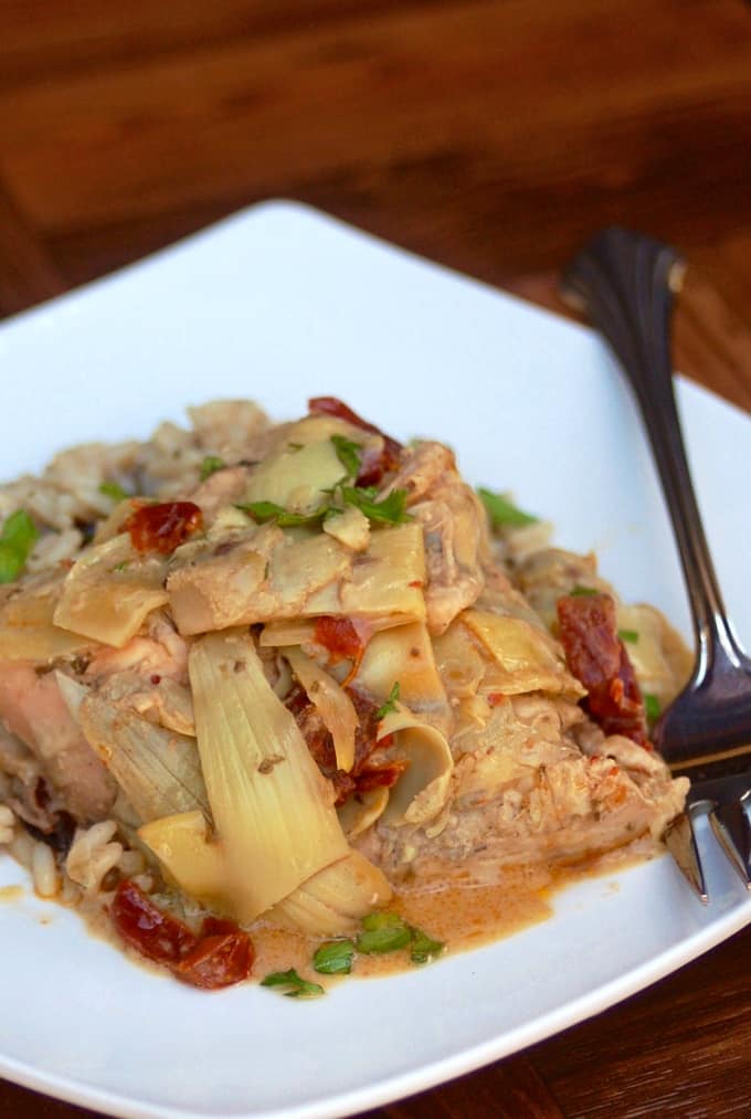 Slow Cooker Goddess Chicken with Artichoke Hearts and Sun Dried Tomatoes on a white plate
