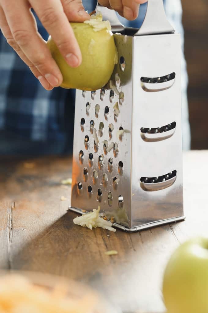 Grating an apple with a box grater