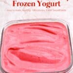 Creamy strawberry frozen yogurt in glass container.