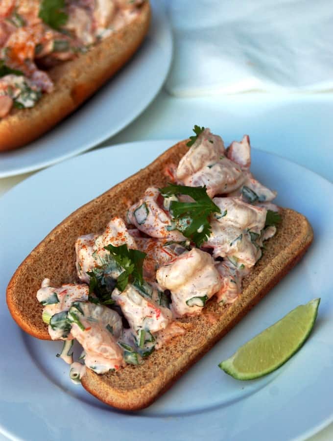 Tex-Mex Shrimp Rolls garnished with fresh cilantro on plate with lime wedge.