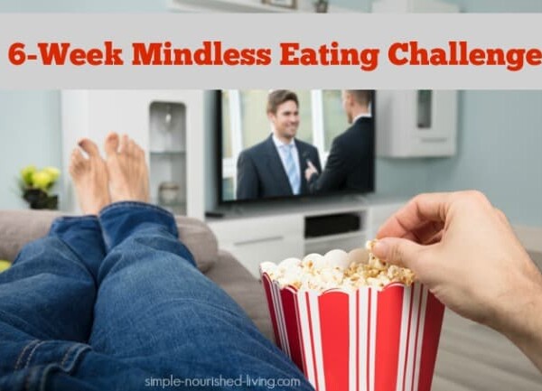 Person wearing jeans in bare feet lying on the sofa eating popcorn while watching television