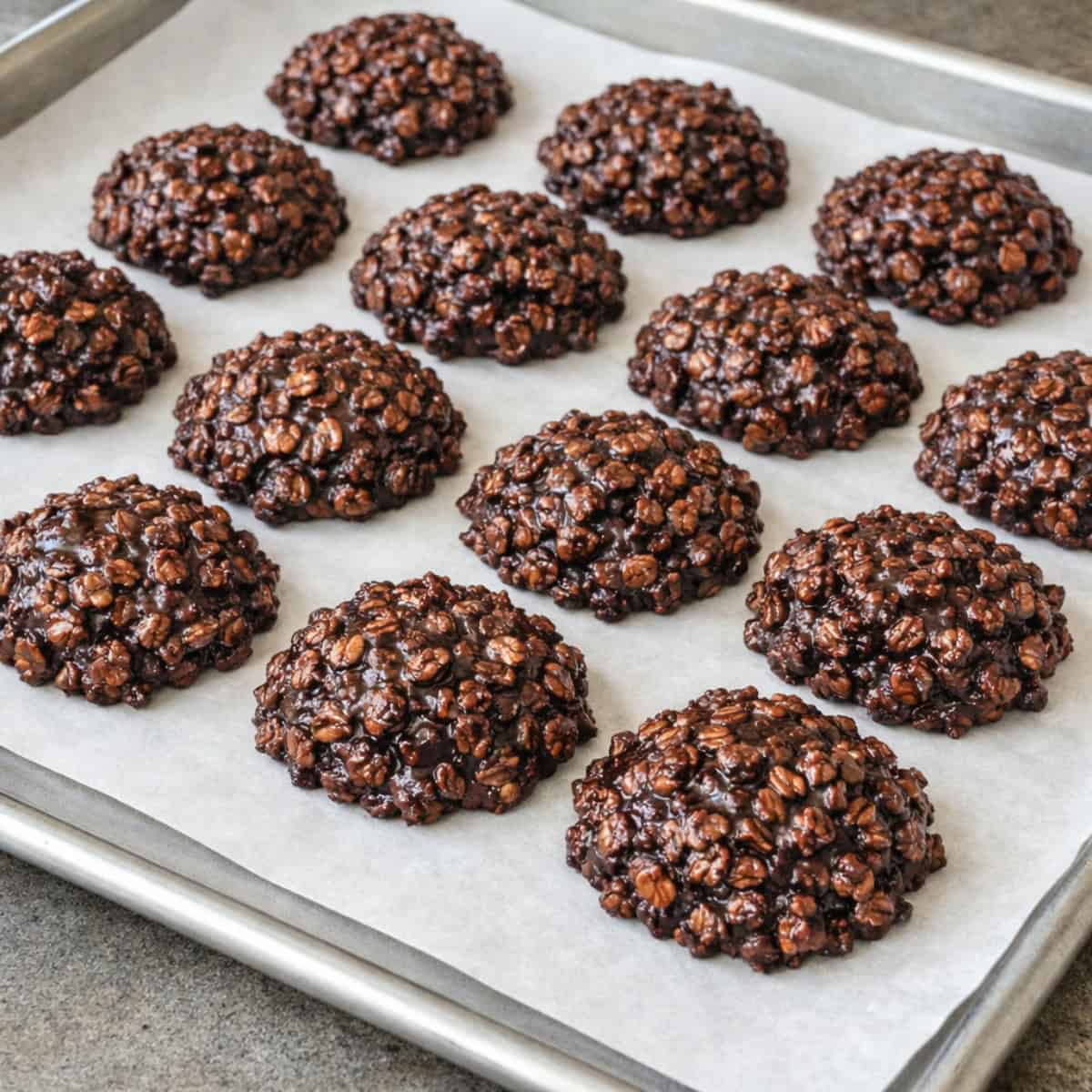 No-Bake Chocolate Peanut Butter Oatmeal Cookies on parchment lined cookie sheet.