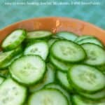 Simple cucumber salad in brown bowl on table.