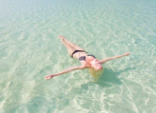 woman in bikini floating in a pool