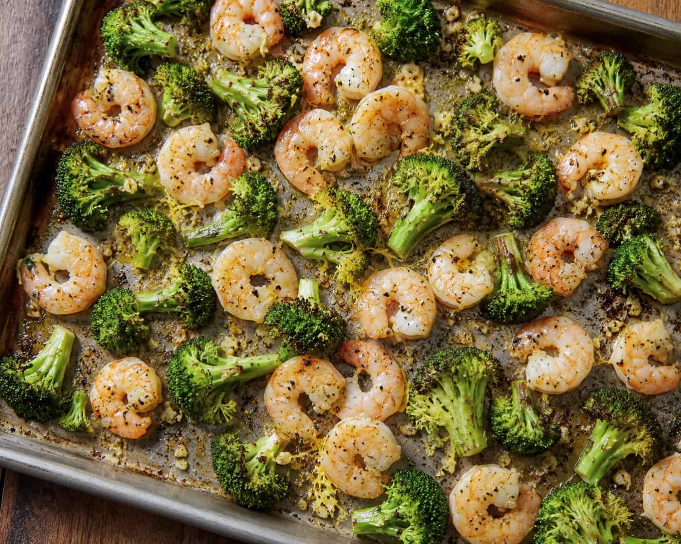 Roasted shrimp and broccoli on a sheet pan.