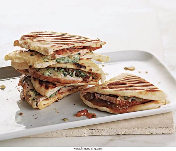 Turkey and Provolone grilled panini sandwich on white plate