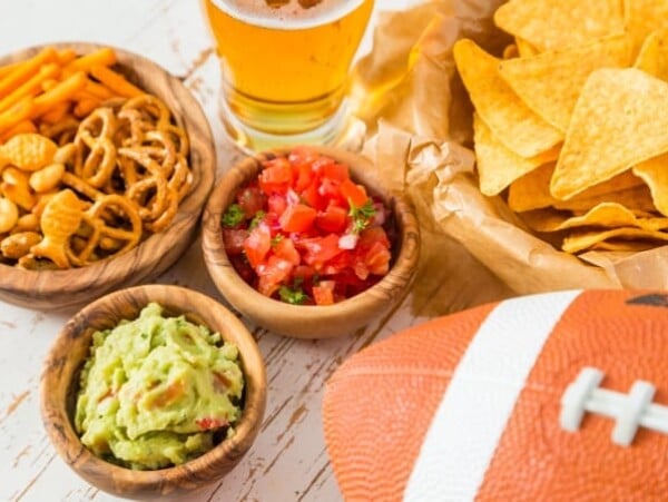 Football party food for Super Bowl Day, nachos, salsa, guacamole, pretzels