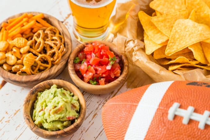 Football party food for Super Bowl Day, nachos, salsa, guacamole, pretzels
