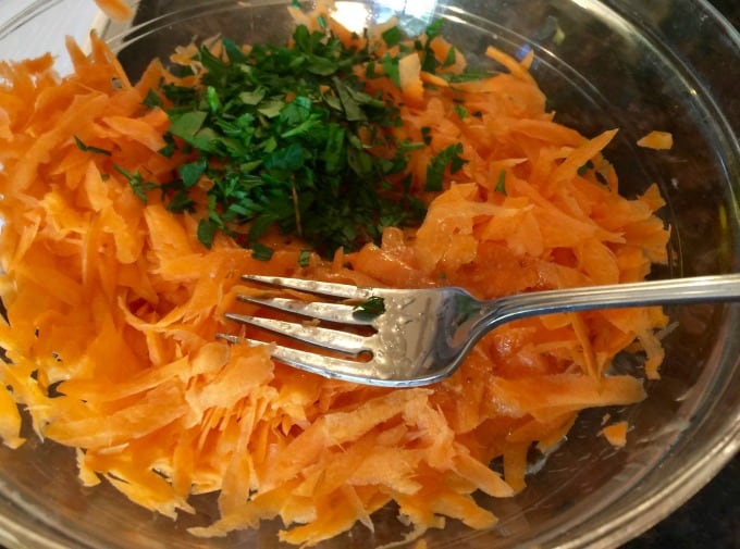 Shredded Carrots, Parsley, Dressing in Clear Bowl with fork