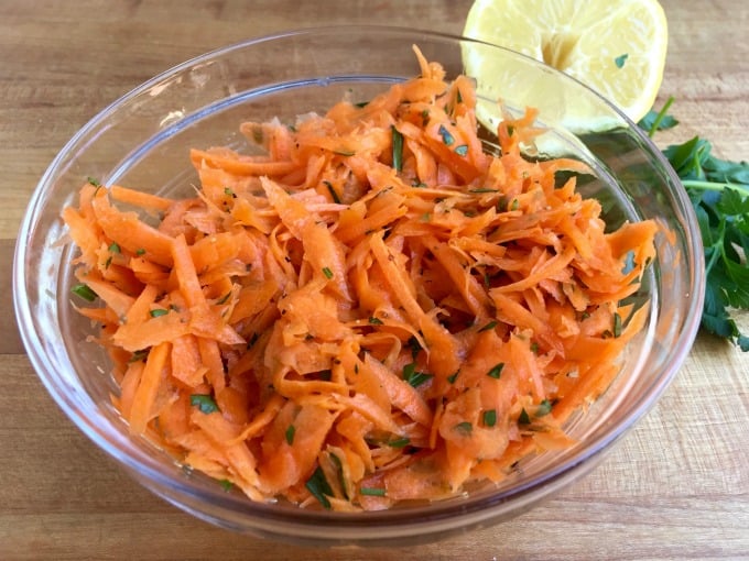 Shredded Carrot Salad Clear Glass Bowl, Parsley & Lemon Background