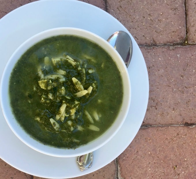 Spinach Florentine Soup in white bowl with spoon.