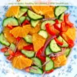 Orange Cucumber Salad with onion and red pepper on a serving platter