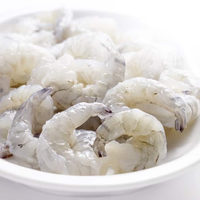 white bowl with raw shrimp
