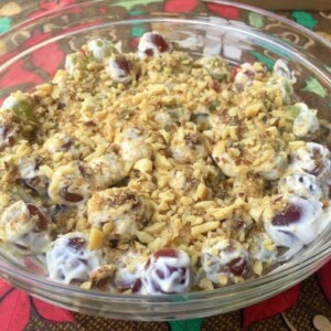Creamy Grape Salad in Clear Glass Bowl Above Colorful Tablecloth