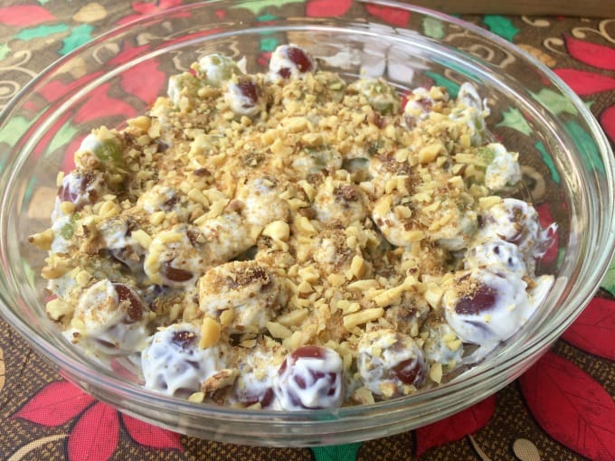 Creamy Grape Salad in Clear Glass Bowl Above Colorful Tablecloth