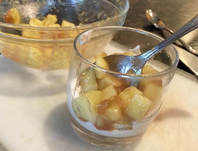 assembling apple pie parfait in a clear glass
