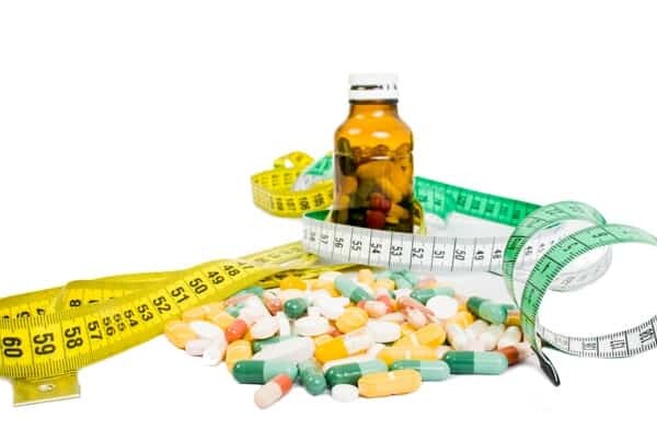 Varios pills and tape measure