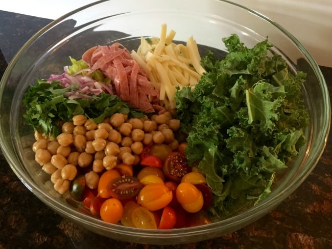 Light healthy italian sub pasta salad ingredients in large bowl.