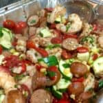 shrimp, sausage, corn, zucchini, tomatoes and spiced in aluminum foil pan