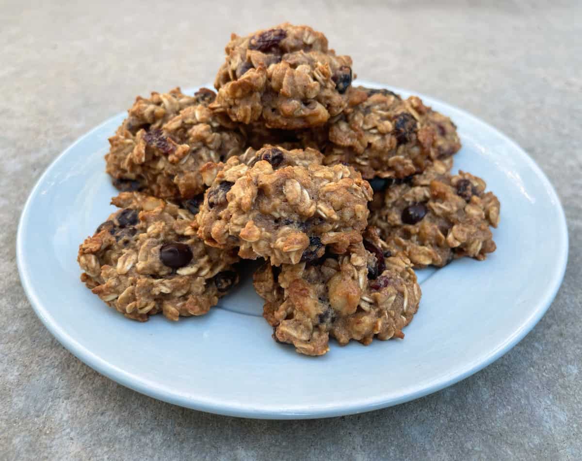 Applesauce Oatmeal Cookies with dried cranberries and chocolate chips on round serving plate.