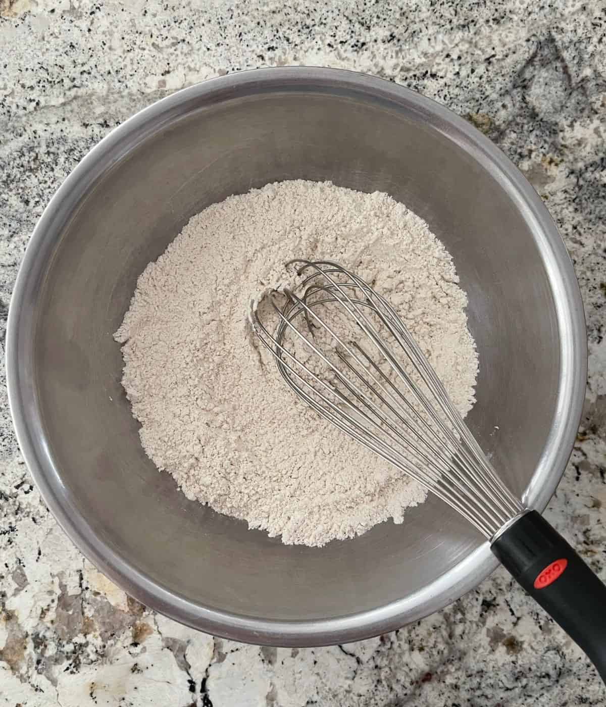 Whisking all-purpose flour, baking soda, salt, cinnamon and allspice in a mixing bowl.