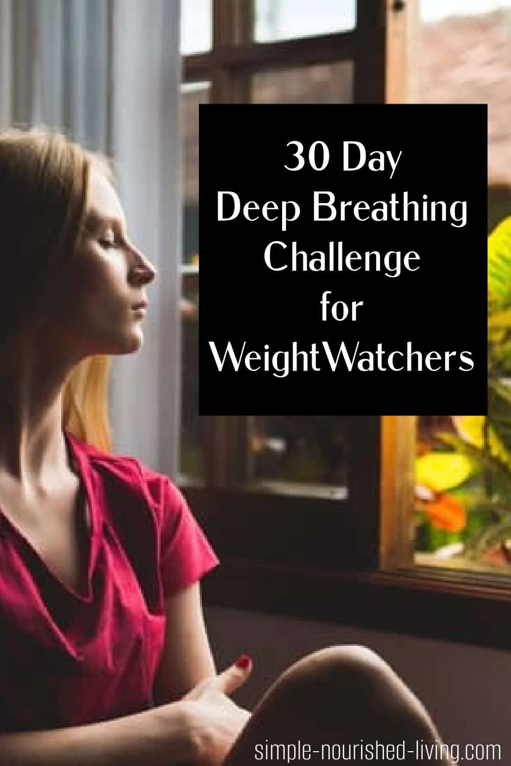 young woman breathing by open window