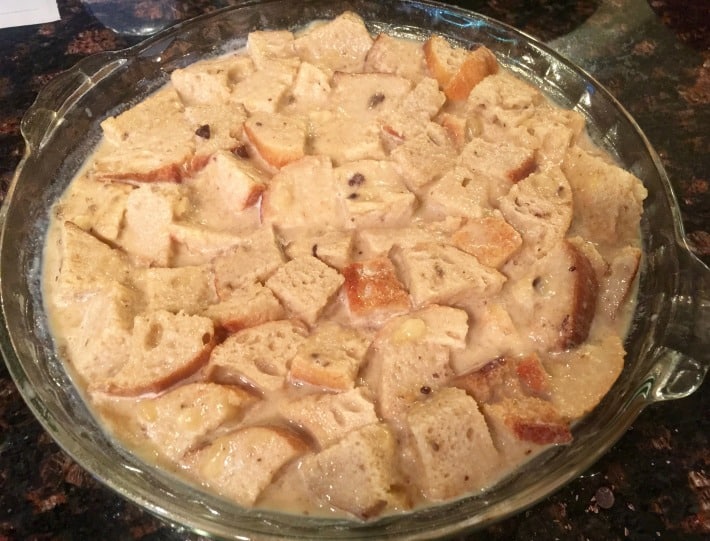 Preparing to bake chocolate banana bread pudding mixture in glass pie plate.