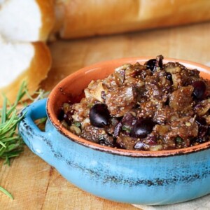 fig tapenade in blue ceramic dish bread background