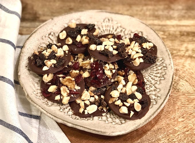 Fruit and Nut Chocolate Clusters with Raisins and Dried Cranberries on a small plate
