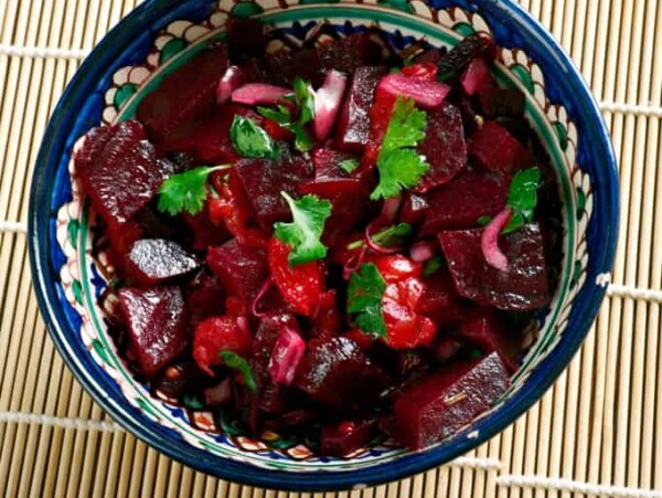 Beet Salad in Blue Ceramic Bowl on Bamboo Mat