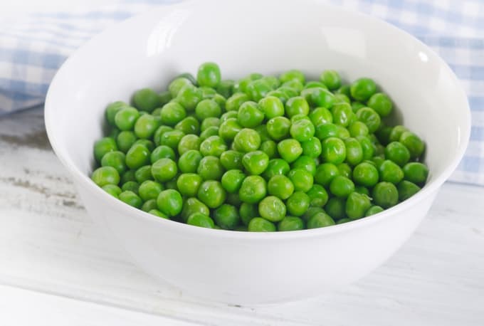 Green peas in a white bowl