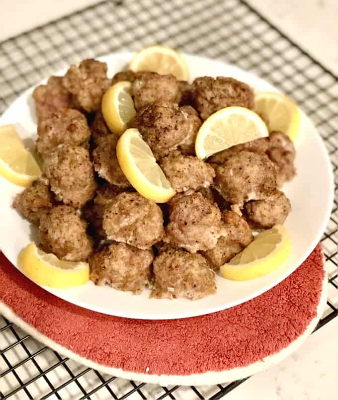 Lemon Pepper Turkey Meatballs on serving plate with lemon wedges