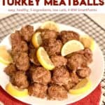 Plate full of low carb lemon pepper turkey meatballs topped with fresh lemon wedges