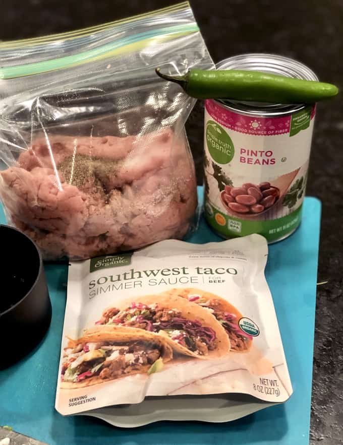 Ground turkey in a ziplock freezer bag, with Southwest taco simmer sauce packet, can of pinto beans and jalapeño pepper