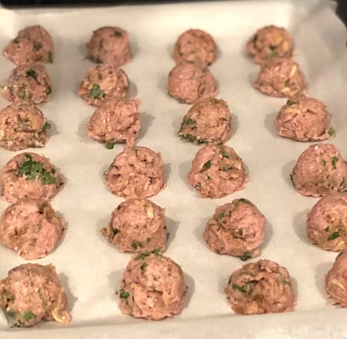 Thai Turkey Meatballs on parchment paper lined baking sheet