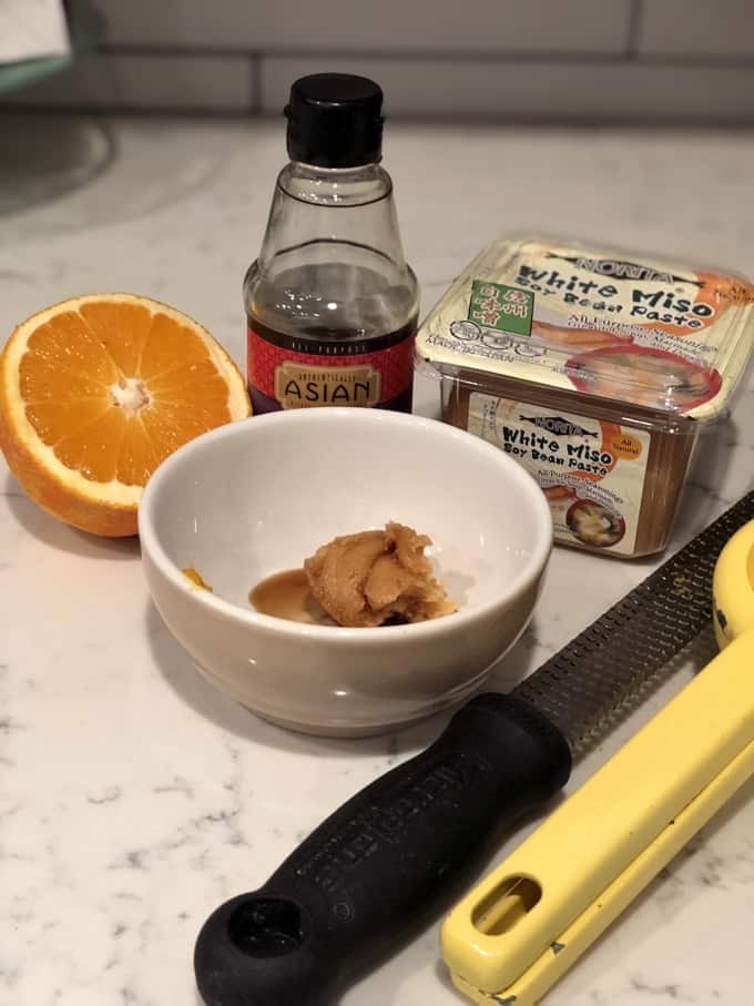 Ingredients including orange, miso paste and soy sauce.