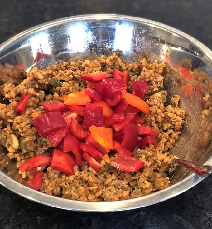 Mixing bowl with leftover Italian ground turkey and chopped bell peppers.