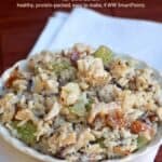 Rotisserie chicken salad with wild rice, grapes and almonds in white serving bowl