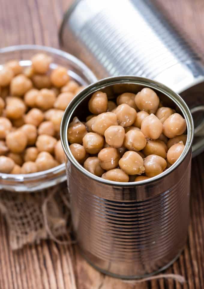 Canned chickpeas (close-up shot) on vintage wooden background
