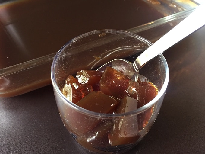 Coffee jello in glass with spoon.