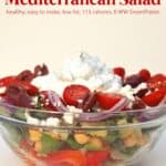 Layered Mediterranean Salad with skinny creamy cucumber dressing in a glass bowl