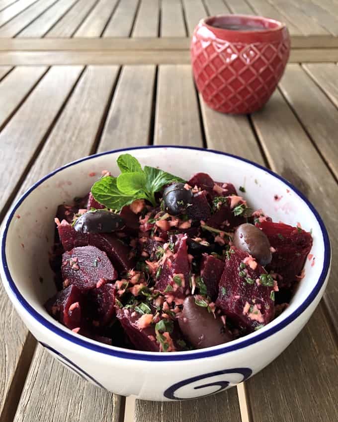 French Beet Salad with Mediterranean Black Olives and mint in serving bowl.