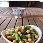 Vegetarian Passover Chickpea Salad in a small white bowl with hand-painted decorative bowl in the background
