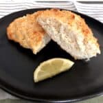 Low-Fat Citrus Scone on black plate with lemon wedge.