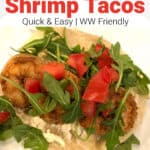 soft shrimp tacos garnished with leafy greens up close shot from above