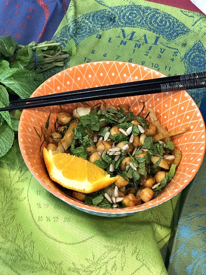 Sauteed smoked chickpeas with fennel and mint in bowl.