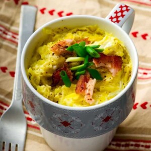 colorful patterned mug with microwave baked salmon omelet within it.