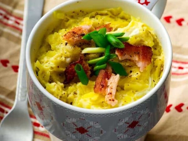 colorful patterned mug with microwave baked salmon omelet within it.