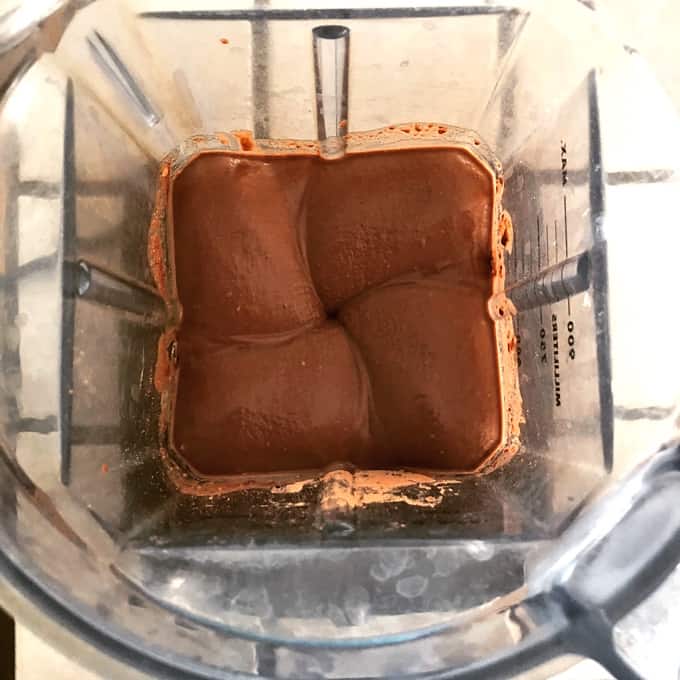 Blending chocolate brownie batter hummus in Vitamix blender.
